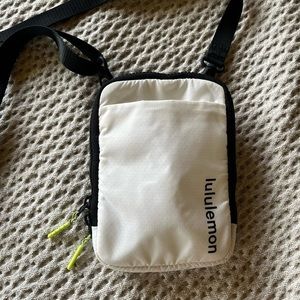 Lululemon cross body bag in white and black, with neon finishes!